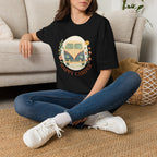 Floral Camper Van 2 T-Shirt in Black, front view on a seated model.