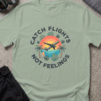 Catching Flights not Feelings T-Shirt in Sage, front view.
