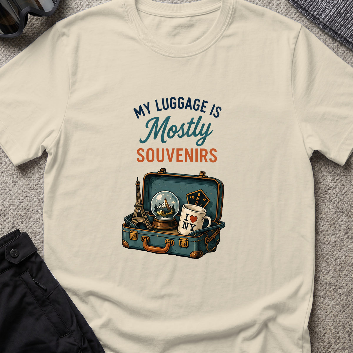 My Luggage is Mostly Souvenirs T-Shirt in Sand, front view.