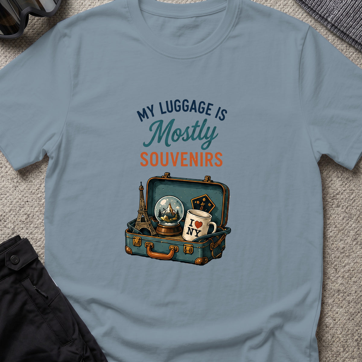 My Luggage is Mostly Souvenirs T-Shirt in Stone Blue, front view.