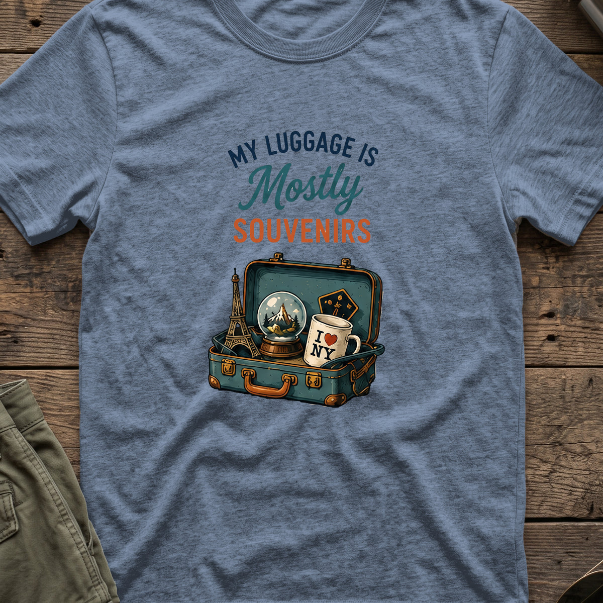 My Luggage is Mostly Souvenirs T-Shirt in Heather Indigo, front view.