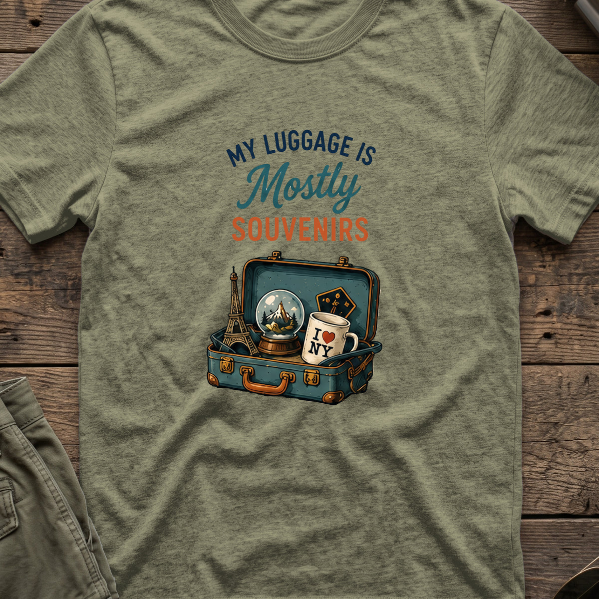 My Luggage is Mostly Souvenirs T-Shirt in Heather Military Green, front view.