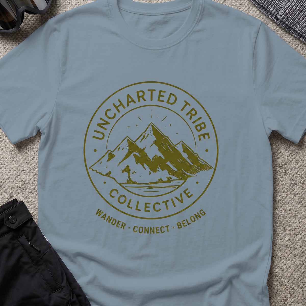 Uncharted Tribe Collective T-Shirt — Mountain Seal in Stone Blue, front view.