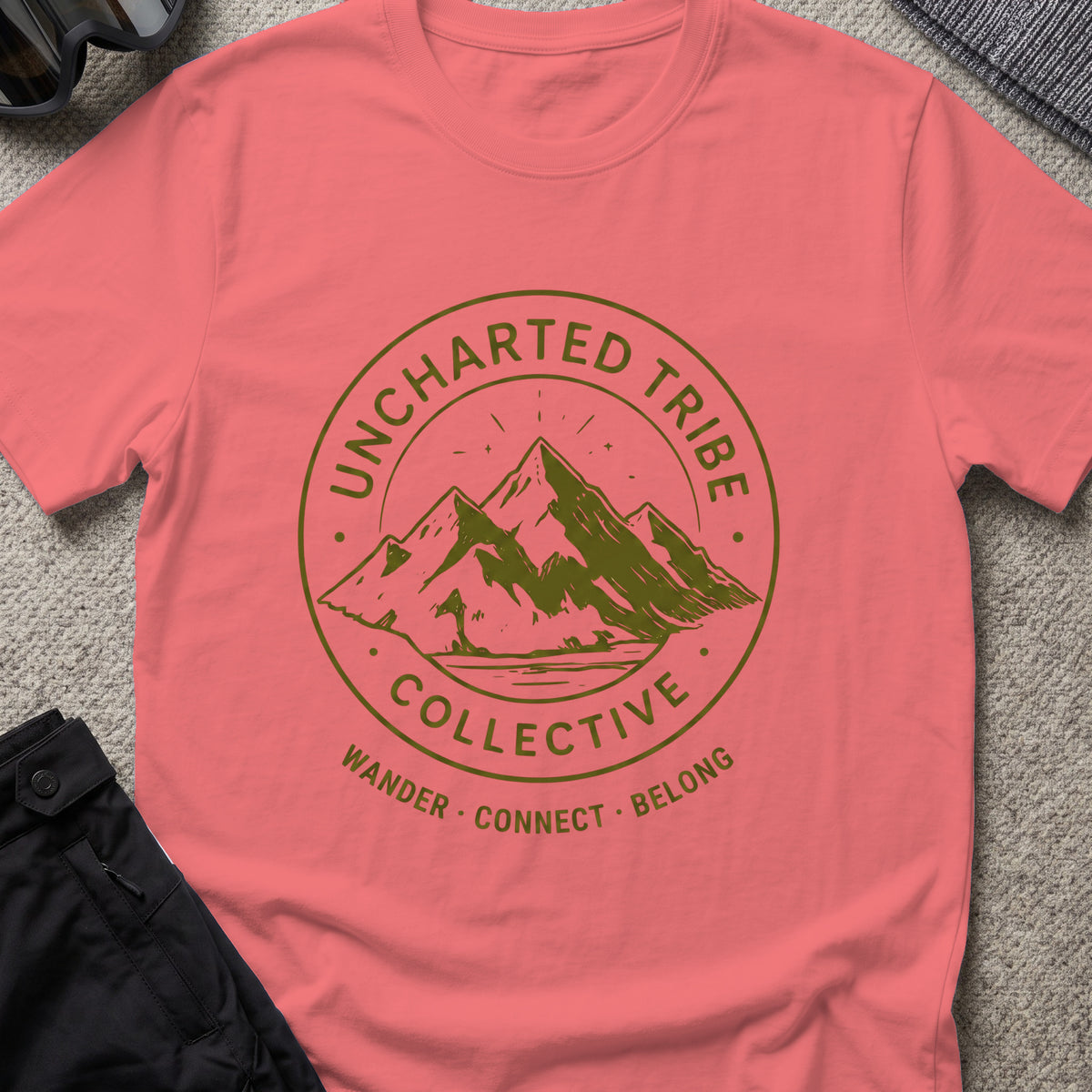 Uncharted Tribe Collective T-Shirt — Mountain Seal in Coral Silk, front view.