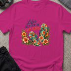 Life's Better in Flip Flops T-Shirt in Antique Heliconia, front view.