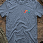 Uncharted Tribe Collective T-Shirt — Shoreline Seal in Heather Indigo, front view.