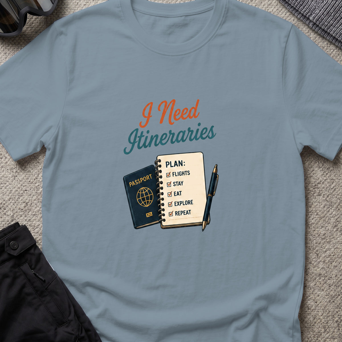 I Need Itineraries T-Shirt in Stone Blue, front view.