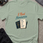 I Need Itineraries T-Shirt in Sage, front view.