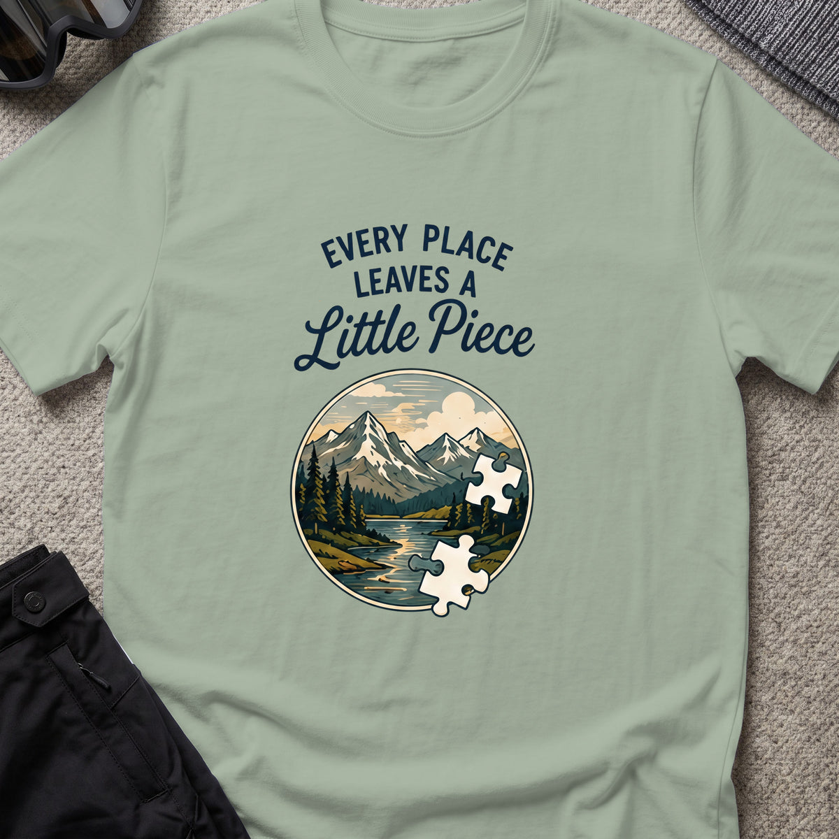 Every Place Leaves a Little Piece T-Shirt in Sage, front view.