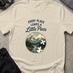 Every Place Leaves a Little Piece T-Shirt in Sand, front view.
