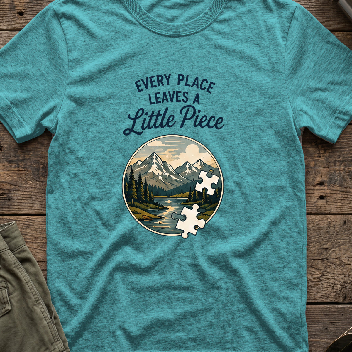 Every Place Leaves a Little Piece T-Shirt in Heather Galapagos Blue, front view.