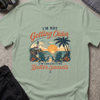 Chasing Better Sunsets T-Shirt in Sage, front view.