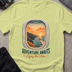 Adventure Awaits T-Shirt — Window Seat in Pistachio, front view.