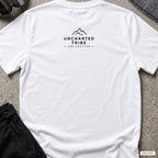 Floral Camera T-shirt in White, back view showing the small Uncharted Tribe Collective logo below the rear neckline.